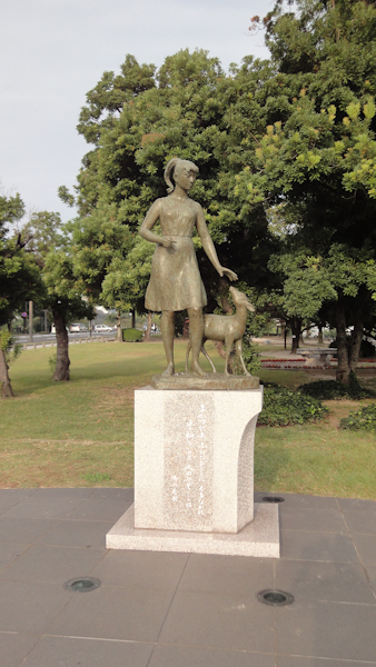 a statue of a girl and a fawn